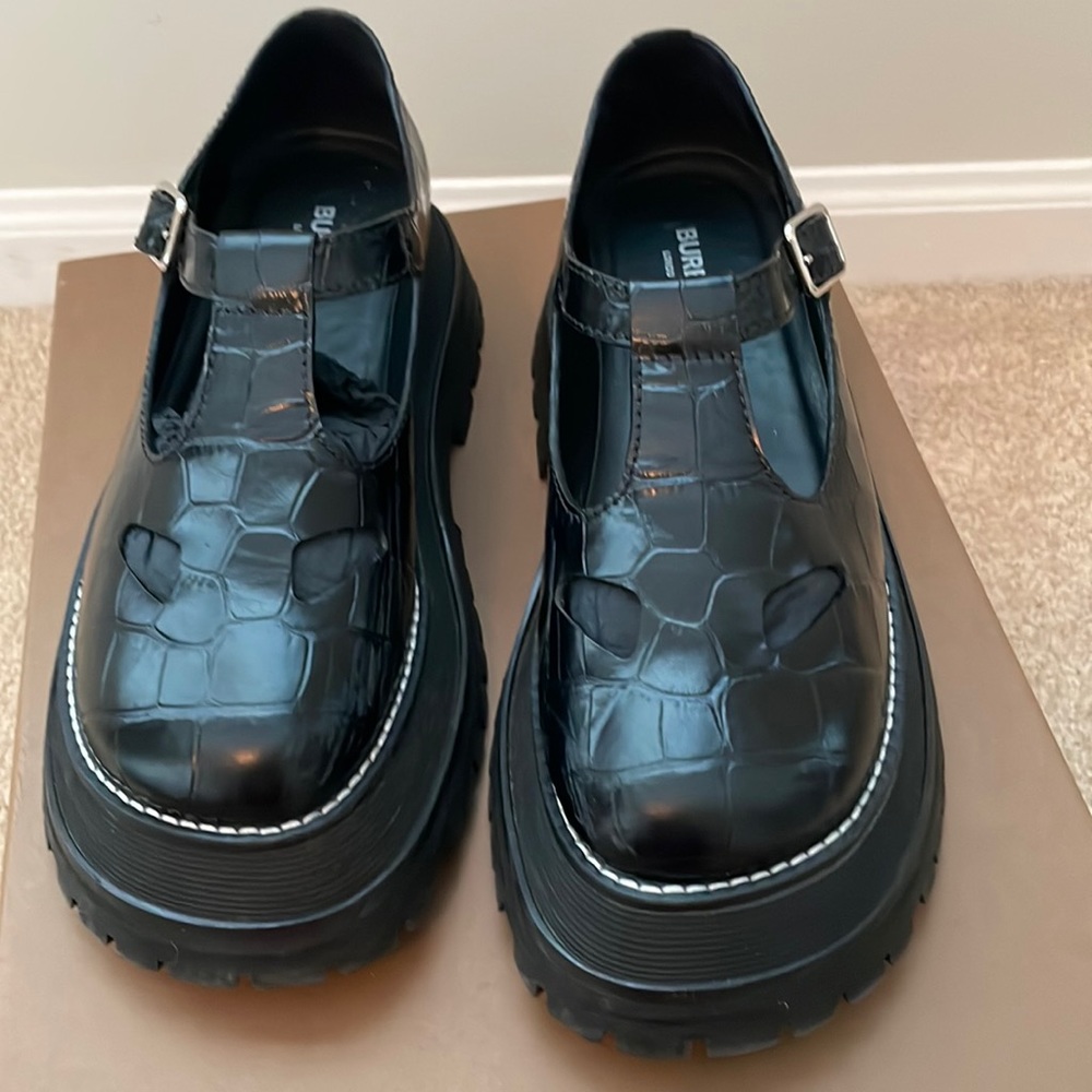 Burberry
Women's Black Embossed Leather T-bar Shoes. Runs small